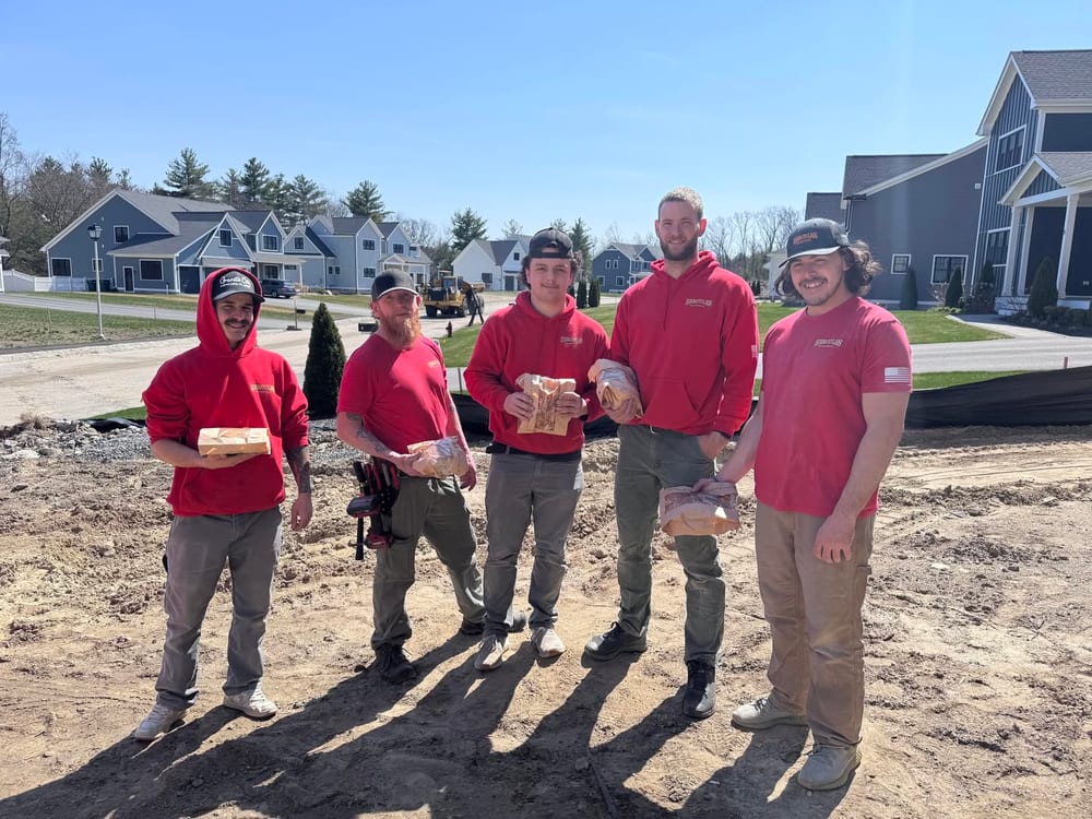 The Hercules Electric crew in red shirts on a job site